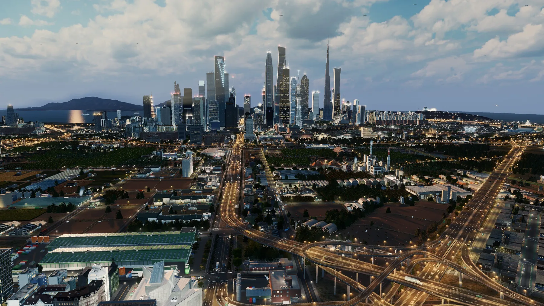 A city in the early morning: a cluster of skyscrapers on the horizon, highway interchanges still lit in the foreground.